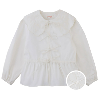 Gingersnaps Mercedes creme meisjesblouse met lange mouwen, striksluitingen en licht uitlopende onderkant.